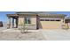 Charming single-story home featuring a two-car garage and desert landscaping at 666 W Pintail Dr, Casa Grande, AZ 85122