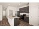 Well-lit kitchen featuring stainless steel appliances, granite countertops, and dark wood cabinets at 666 W Pintail Dr, Casa Grande, AZ 85122