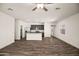 Spacious living room showcasing wood floors, recessed lighting, and an open floor plan to the kitchen at 666 W Pintail Dr, Casa Grande, AZ 85122