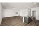 Bright open-concept living area showcasing wood floors, neutral paint, and a kitchen island at 666 W Pintail Dr, Casa Grande, AZ 85122