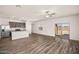 Open-concept living room featuring wood floors, stainless steel appliances, and sliding glass doors at 666 W Pintail Dr, Casa Grande, AZ 85122