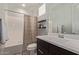 Well-lit bathroom features a sleek vanity, modern fixtures, tub with stylish shower curtain, and decorative tile flooring at 6931 W Spur Dr, Peoria, AZ 85383