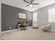 Bedroom with neutral tones features a ceiling fan, carpeted floor, and a modern work space with desk and chairs at 6931 W Spur Dr, Peoria, AZ 85383