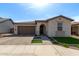 Charming single-story home featuring a well-manicured front yard and a two-car garage at 6931 W Spur Dr, Peoria, AZ 85383