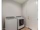 Well-lit laundry room with modern white washer and dryer units at 6931 W Spur Dr, Peoria, AZ 85383