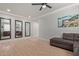 Spacious living room with wood floors, large mirrors, and a comfortable gray sofa at 6931 W Spur Dr, Peoria, AZ 85383