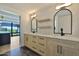 Well-lit bathroom features dual sinks, quartz countertop, and wooden cabinets at 7161 E Rancho Vista Dr # 6009, Scottsdale, AZ 85251