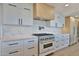 Modern kitchen featuring white marble countertops, a stainless steel range, and stylish cabinetry at 7161 E Rancho Vista Dr # 6009, Scottsdale, AZ 85251