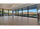 Bright living room with floor-to-ceiling windows with exterior views and light-colored hardwood floors at 7161 E Rancho Vista Dr # 6009, Scottsdale, AZ 85254