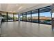 Bright living room with floor-to-ceiling windows with exterior views and light-colored hardwood floors at 7161 E Rancho Vista Dr # 6009, Scottsdale, AZ 85251