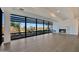 Bright living room featuring floor-to-ceiling windows with exterior views, a fireplace, and light-colored hardwood floors at 7161 E Rancho Vista Dr # 6009, Scottsdale, AZ 85251