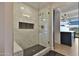 Bright bathroom features a frameless glass shower with white tiled walls and black accents at 7161 E Rancho Vista Dr # 6009, Scottsdale, AZ 85254