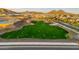 Scenic aerial view of green space in a new construction community at sunset with mountain views at 7378 W Whitehorn Trl, Peoria, AZ 85383