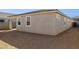 Image of the backyard, with a tan house, dirt yard, and block fence at 7378 W Whitehorn Trl, Peoria, AZ 85383