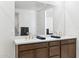 This bathroom features a double sink vanity, granite countertops, and a large mirror for a spacious feel at 7378 W Whitehorn Trl, Peoria, AZ 85383