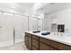 Bathroom featuring a walk-in shower, double sink vanity, and modern finishes for a luxurious experience at 7378 W Whitehorn Trl, Peoria, AZ 85383