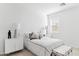 Bright bedroom featuring white walls, a patterned accent pillows, and bedside tables for relaxation at 7378 W Whitehorn Trl, Peoria, AZ 85383