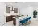 Beautiful kitchen with a center island, stylish bar stools and stainless steel hood at 7378 W Whitehorn Trl, Peoria, AZ 85383