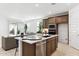 Well-designed kitchen with stainless steel appliances and a view into the living room at 7378 W Whitehorn Trl, Peoria, AZ 85383