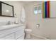 Clean bathroom with a white vanity and a window that lets in natural light at 7515 N 185Th Ave, Waddell, AZ 85355