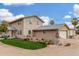 Charming two-story stucco home with manicured grass and multiple car garage under sunny blue sky at 7515 N 185Th Ave, Waddell, AZ 85355