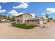 Charming two-story stucco home with well-manicured landscaping and multiple car garage under sunny blue sky at 7515 N 185Th Ave, Waddell, AZ 85355