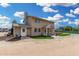 Charming two-story stucco home with well-manicured landscaping and covered entry, under sunny blue sky at 7515 N 185Th Ave, Waddell, AZ 85355