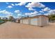 Exterior of the garage building, complete with three garage doors and parking area at 7515 N 185Th Ave, Waddell, AZ 85355