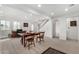 Bright living room featuring wood-look floors, staircase, and large windows with mountain views at 7515 N 185Th Ave, Waddell, AZ 85355