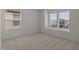 Well-lit bedroom with two windows offering pleasant neighborhood views and privacy blinds at 7988 W Griswold Rd, Peoria, AZ 85345