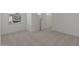 Carpeted bedroom with a window and a door leading to the hallway for easy access at 7988 W Griswold Rd, Peoria, AZ 85345