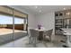 Cozy dining area with circular rug, table with flowers, and sliding glass doors leading to the backyard patio at 7988 W Griswold Rd, Peoria, AZ 85345