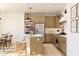 Modern kitchen featuring an island with bar stools, stainless steel appliances, and wood cabinetry at 7988 W Griswold Rd, Peoria, AZ 85345