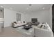 Spacious living area featuring tile floors and modern furnishings including sofa and armchairs at 7988 W Griswold Rd, Peoria, AZ 85345