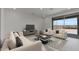 Comfortable living room with contemporary furnishings and sliding glass doors to the backyard at 7988 W Griswold Rd, Peoria, AZ 85345