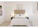 Serene main bedroom with a tufted headboard, soft lighting, and neutral decor at 7988 W Griswold Rd, Peoria, AZ 85345