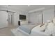 Well-designed Primary bedroom boasts tray ceiling, a TV, decor and a sliding barn door to the Primary bath at 7988 W Griswold Rd, Peoria, AZ 85345