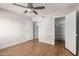 Bedroom featuring wood floors, a ceiling fan, and a double closet with open doors at 9355 N 91St St # 113, Scottsdale, AZ 85258