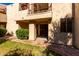 Exterior of building featuring second story balcony and entrance into the home at 9355 N 91St St # 113, Scottsdale, AZ 85258