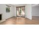 Bright and airy living room featuring wood-look floors and a sliding door to a private patio at 9355 N 91St St # 113, Scottsdale, AZ 85258