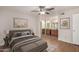 Comfortable main bedroom featuring a ceiling fan, wood-look floors, and ensuite bath with double sink vanity at 9355 N 91St St # 113, Scottsdale, AZ 85258