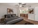 Spacious main bedroom with wood-look flooring, ceiling fan, and ensuite bath with double sink vanity at 9355 N 91St St # 113, Scottsdale, AZ 85258