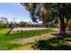 Exterior shot of community tennis courts with mature trees and nearby building at 9355 N 91St St # 113, Scottsdale, AZ 85258