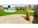 This backyard features a swimming pool, artificial turf, and desert landscaping at 9654 N 94Th Ave, Peoria, AZ 85345