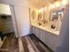 Bathroom featuring double sinks, decorative lighting, and a sleek design at 9654 N 94Th Ave, Peoria, AZ 85345