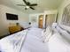 Bright bedroom featuring wood look floors, ceiling fan, and serene atmosphere at 9654 N 94Th Ave, Peoria, AZ 85345