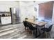 Stylish dining area featuring stainless steel appliances, wood-look floors, and a modern table set at 9654 N 94Th Ave, Peoria, AZ 85345