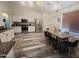 Bright and airy dining area featuring stainless steel appliances and wood-look floors at 9654 N 94Th Ave, Peoria, AZ 85345