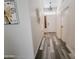 Bright hallway featuring modern wood-look flooring, stylish lighting, and contemporary decor at 9654 N 94Th Ave, Peoria, AZ 85345