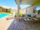 This covered patio is perfect for entertaining with comfortable seating overlooking the pool at 9654 N 94Th Ave, Peoria, AZ 85345